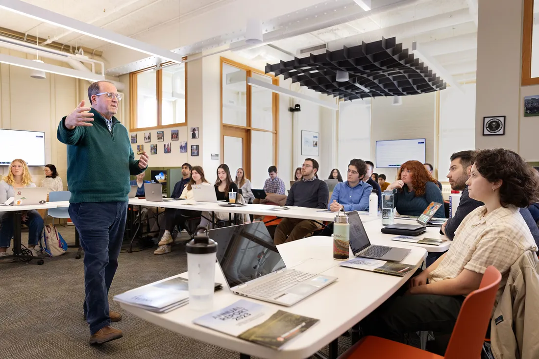 Dr. Jay Golde and students in a classroom.